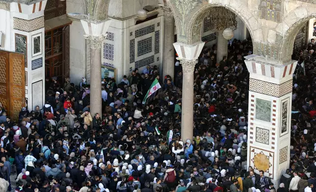 Syrians attend Friday prayers outside the 7th century Umayyad Mosque in Damascus, Syria, Friday, Dec. 13, 2024. (AP Photo/Omar Sanadiki)