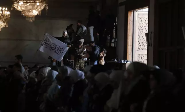 Syrians attend Friday prayers inside the 7th century Umayyad Mosque in Damascus, Syria, Friday, Dec. 13, 2024. (AP Photo/Omar Sanadiki)