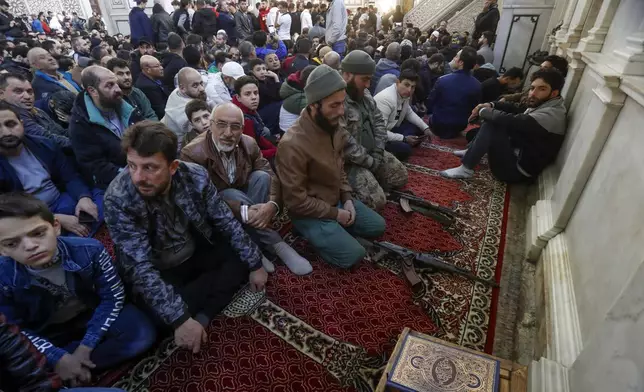 Syrians attend Friday prayers inside the 7th century Umayyad Mosque in Damascus, Syria, Friday, Dec. 13, 2024. (AP Photo/Omar Sanadiki)