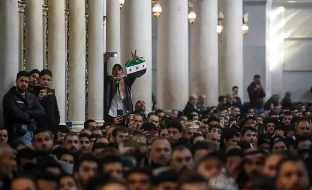 Syrians attend Friday prayers inside the 7th century Umayyad Mosque in Damascus, Syria, Friday, Dec. 13, 2024. (AP Photo/Omar Sanadiki)