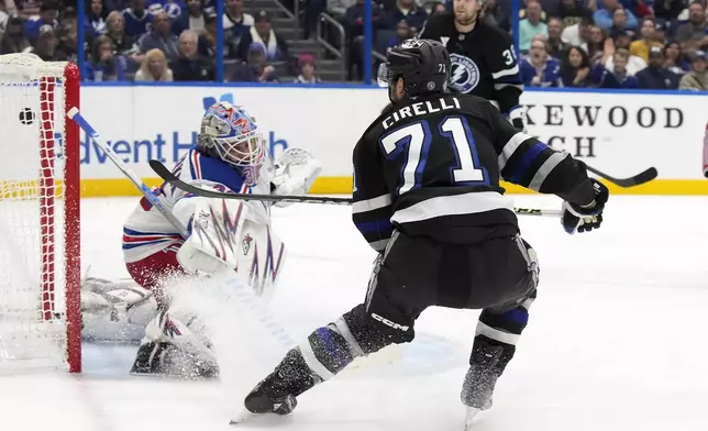 Tampa Bay Lightning center Anthony Cirelli (71) scores past New York Rangers goaltender Igor Shesterkin (31) during the second period of an NHL hockey game Saturday, Dec. 28, 2024, in Tampa, Fla. (AP Photo/Chris O'Meara)