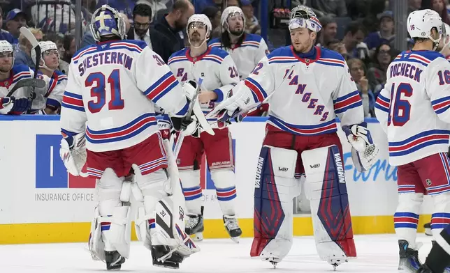 New York Rangers goaltender Igor Shesterkin (31) is replaced by goaltender Jonathan Quick (32) during the second period of an NHL hockey game against the Tampa Bay Lightning, Saturday, Dec. 28, 2024, in Tampa, Fla. (AP Photo/Chris O'Meara)