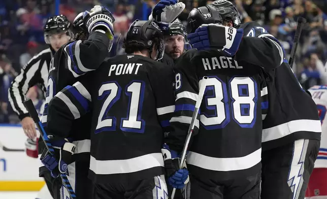 Tampa Bay Lightning center Brayden Point (21) celebrates after his goal against the New York Rangers with teammates during the second period of an NHL hockey game Saturday, Dec. 28, 2024, in Tampa, Fla. (AP Photo/Chris O'Meara)