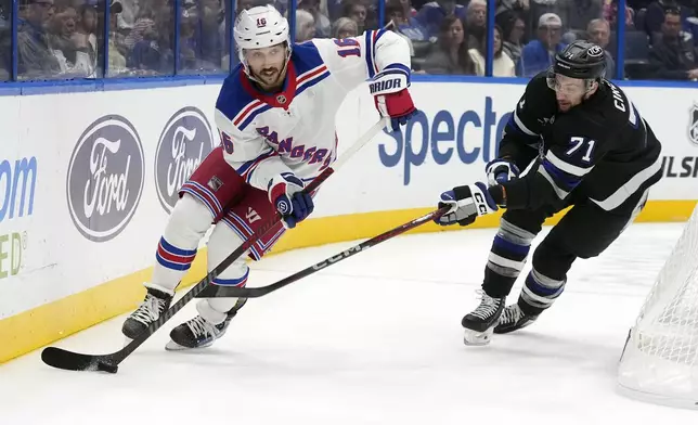 New York Rangers center Vincent Trocheck (16) skates ahead of Tampa Bay Lightning center Anthony Cirelli (71) during the first period of an NHL hockey game Saturday, Dec. 28, 2024, in Tampa, Fla. (AP Photo/Chris O'Meara)