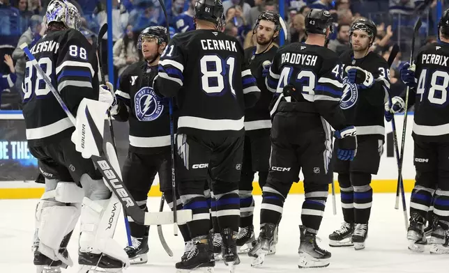 Tampa Bay Lightning players celebrate after their win over the New York Rangers in an NHL hockey game Saturday, Dec. 28, 2024, in Tampa, Fla. (AP Photo/Chris O'Meara)