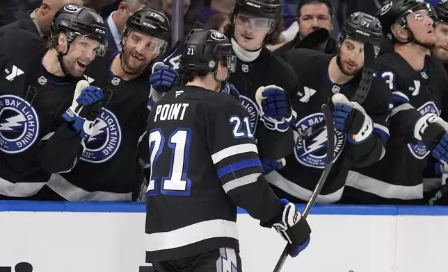 Tampa Bay Lightning center Brayden Point (21) celebrates with the bench after his goal against the New York Rangers during the second period of an NHL hockey game Saturday, Dec. 28, 2024, in Tampa, Fla. (AP Photo/Chris O'Meara)