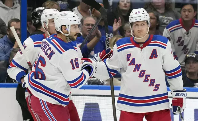 New York Rangers center Vincent Trocheck (16) celebrates after his goal against the Tampa Bay Lightning with defenseman Adam Fox (23) during the third period of an NHL hockey game Saturday, Dec. 28, 2024, in Tampa, Fla. (AP Photo/Chris O'Meara)