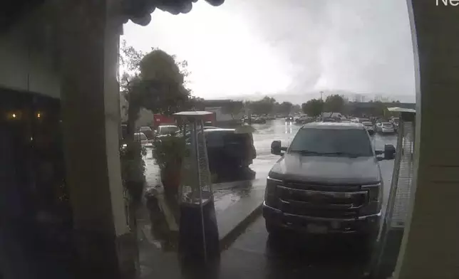 This image made from video provided Bruno's Bar and Grill shows a tornado descending on Scotts Valley, Calif., Saturday, Dec. 14, 2024. (Bruno's Bar and Grill via AP)