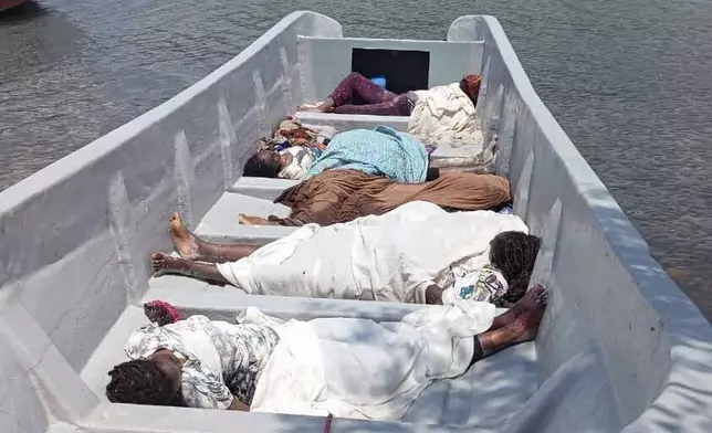 EDS NOTE: GRAPHIC CONTENT - Bodies of migrants who were washed away after two boats capsized are seen on the shore of the Madagascar coast in the Indian Ocean, Saturday, Nov. 23, 2024. (AP Photo/Bebel Betombo)