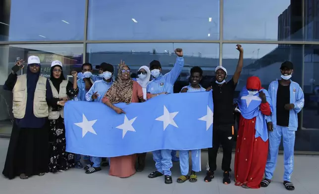Survivors of a boat tragedy that killed dozens of Somali migrants off the coast of Madagascar arrive at Aden Adde International Airport in Mogadishu, Somalia, Saturday, Nov. 7, 2024. (AP Photo/Farah Abdi Warsameh)
