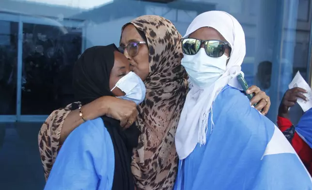 Survivors of a boat tragedy that killed dozens of Somali migrants off the coast of Madagascar arrive at Aden Adde International Airport in Mogadishu, Somalia, Saturday, Nov. 7, 2024. (AP Photo/Farah Abdi Warsameh)