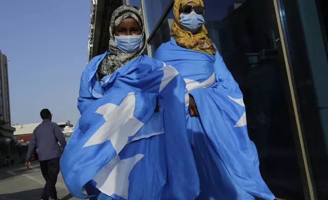 Survivors of a boat tragedy that killed dozens of Somali migrants off the coast of Madagascar arrive at Aden Adde International Airport in Mogadishu, Somalia, Saturday, Nov. 7, 2024. (AP Photo/Farah Abdi Warsameh)