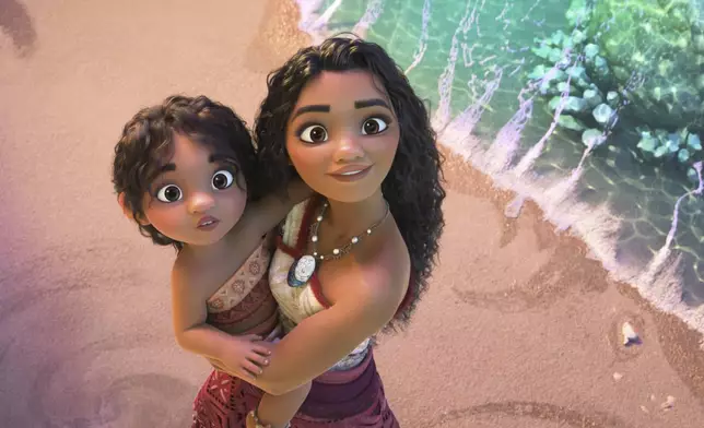 This image released by Disney shows the characters Moana, voiced by Auli'i Cravalho, holding Simea, voiced by Khaleesi Lambert-Tsuda, in a scene from "Moana 2." (Disney via AP)