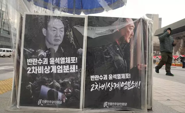 Posters are displayed demanding the arrest of impeached South Korean President Yoon Suk Yeol in Seoul, South Korea, Friday, Dec. 20, 2024. The signs read "Arrest the rebellion leader Yoon Suk Yeol." (AP Photo/Ahn Young-joon)