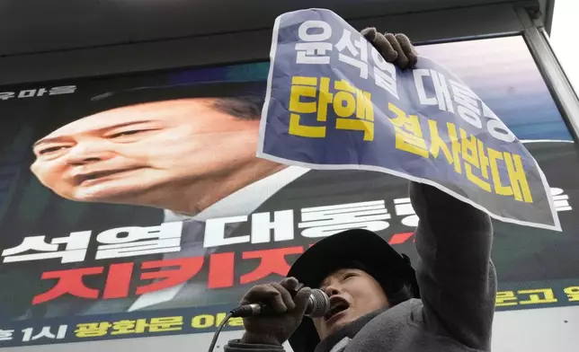 A supporter for impeached South Korean President Yoon Suk Yeol shouts slogans during a rally against his impeachment near the Constitutional Court in Seoul, South Korea, Friday, Dec. 20, 2024. The signs read "Oppose the impeachment of President Yoon Suk Yeol." (AP Photo/Ahn Young-joon)