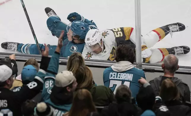 San Jose Sharks center Will Smith, top left, and Vegas Golden Knights right wing Keegan Kolesar (55) collide during the second period of an NHL hockey game, Friday, Dec. 27, 2024, in San Jose, Calif. (AP Photo/Godofredo A. Vásquez)