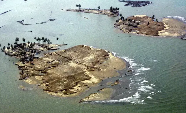 Islets are formed of what used to be part of Banda Aceh, the capital of Aceh province in northwest of Indonesia, as seen from a commercial plane on Thursday Dec. 30, 2004 following Sunday's earthquake-triggered tsunami. (AP Photo/Eugene Hoshiko, File)