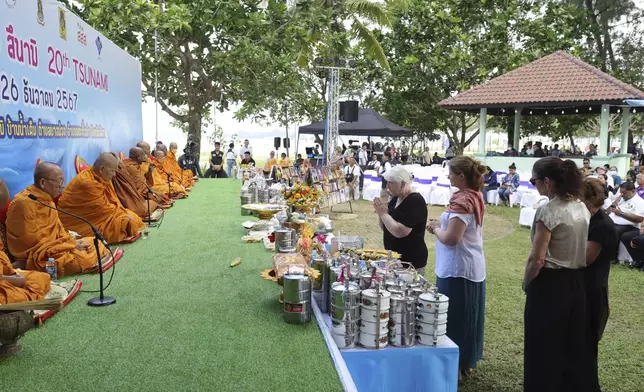 Relatives of a victim of a 2004 Indian Ocean tsunami participate in its 20th anniversary at Tsunami Memorial Park at Ban Nam Khem, Takuapa district of Phang Nga province, southern Thailand, Thursday, Dec. 26, 2024. (AP Photo/Wason Wannichakorn)