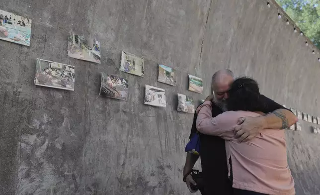 Relatives of a victim of a 2004 Indian Ocean tsunami hug each other during its 20th anniversary at Tsunami Memorial Park at Ban Nam Khem, Takuapa district of Phang Nga province, southern Thailand, Thursday, Dec. 26, 2024. (AP Photo/Wason Wanichakorn)