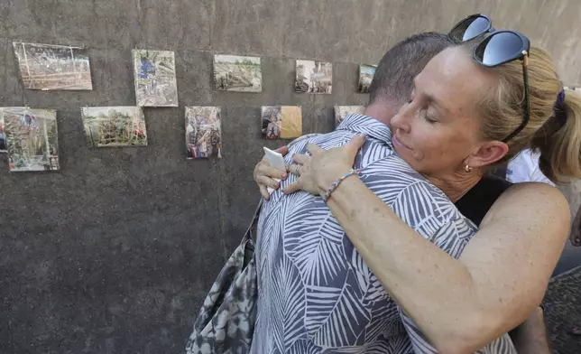 Relatives of a victim of a 2004 Indian Ocean tsunami hug each other during its 20th anniversary at Tsunami Memorial Park at Ban Nam Khem, Takuapa district of Phang Nga province, southern Thailand, Thursday, Dec. 26, 2024. (AP Photo/Wason Wanichakorn)