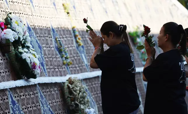 Relatives of a victim of a 2004 Indian Ocean tsunami pray during its 20th anniversary at Tsunami Memorial Park at Ban Nam Khem, Takuapa district of Phang Nga province, southern Thailand, Thursday, Dec. 26, 2024. (AP Photo/Wason Wanichakorn)