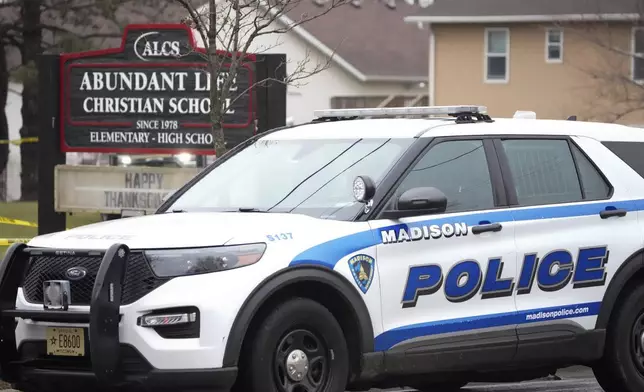 Emergency vehicles are parked outside the Abundant Life Christian School in Madison, Wis., where multiple injuries were reported following a shooting, Monday, Dec. 16, 2024. (AP Photo/Morry Gash)