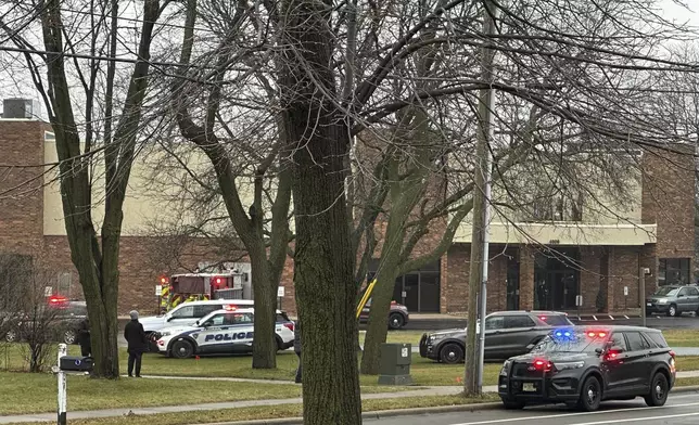 Emergency vehicles are parked outside the Abundant Life Christian School in Madison, Wis., where multiple injuries were reported following a shooting, Monday, Dec. 16, 2024. (AP Photo/Scott Bauer)