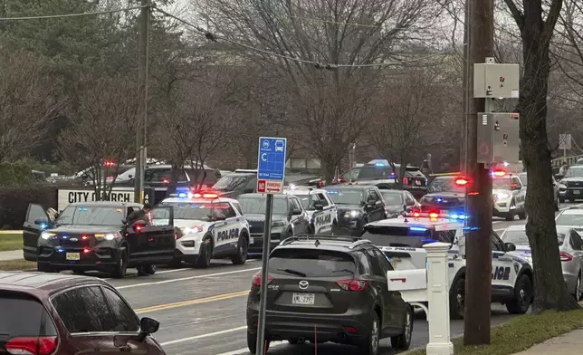 Emergency vehicles are parked outside the Abundant Life Christian School in Madison, Wis., where multiple injuries were reported following a shooting, Monday, Dec. 16, 2024. (AP Photo/Scott Bauer)