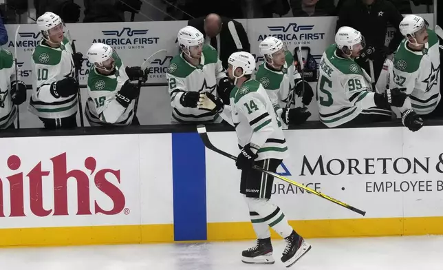 Dallas Stars left wing Jamie Benn (14) celebrates with teammates after scoring against the Utah Hockey Club during the second period of an NHL hockey game Monday, Dec. 2, 2024, in Salt Lake City. (AP Photo/Rick Bowmer)