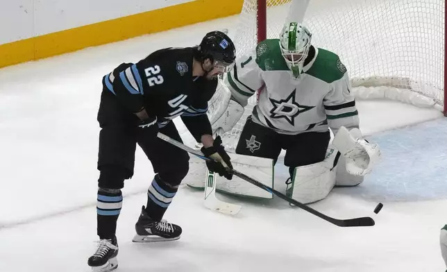 Dallas Stars goaltender Casey DeSmith (1) makes a save against Utah Hockey Club center Jack McBain (22) during the second period of an NHL hockey game Monday, Dec. 2, 2024, in Salt Lake City. (AP Photo/Rick Bowmer)