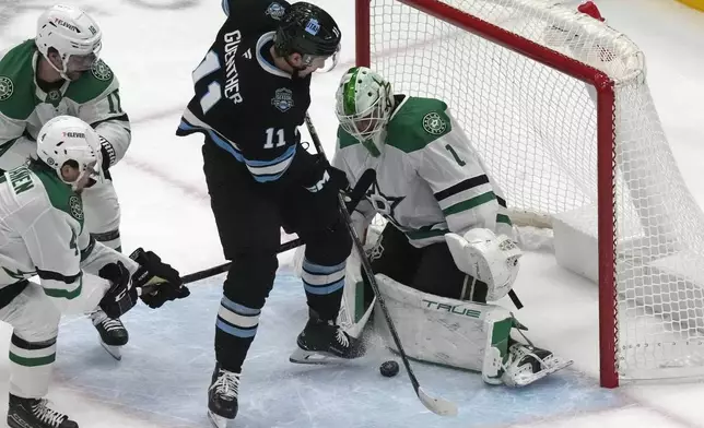 Dallas Stars goaltender Casey DeSmith (1) makes a save against Utah Hockey Club right wing Dylan Guenther (11) during the first period of an NHL hockey game Monday, Dec. 2, 2024, in Salt Lake City. (AP Photo/Rick Bowmer)