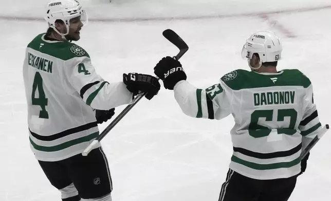 Dallas Stars right wing Evgenii Dadonov (63) celebrates with teammate Miro Heiskanen (4) after scoring against the Utah Hockey Club during the second period of an NHL hockey game Monday, Dec. 2, 2024, in Salt Lake City. (AP Photo/Rick Bowmer)