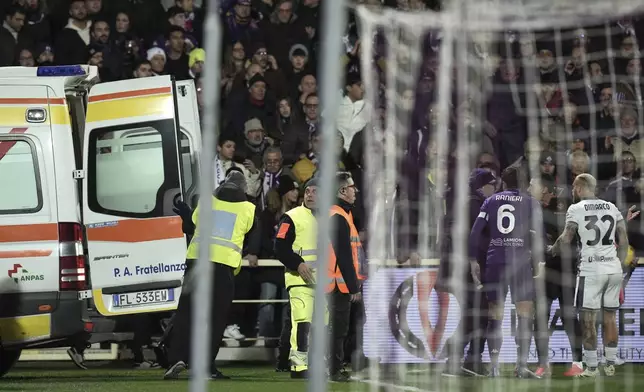 An ambulance enters the field as Fiorentina's Edoardo Bove, injured, is surrounded by players during the Serie A soccer match between Fiorentina and Inter at the Artemio Franchi Stadium in Florence, Italy, Sunday Dec. 1, 2024. The match was suspended and finally postponed as the injures appeared to be serious. (Massimo Paolone/LaPresse via AP)