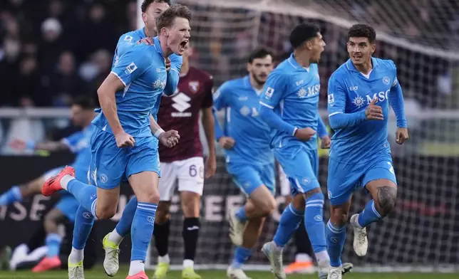 Napoli's Scott McTominay, left, celebrates after scoring his side's first goal during the Serie A soccer match between Torino FC and SSC Napoli the Stadio Olimpico Grande Torino in Turin, north west Italy, Sunday, Nov. 24, 2024. (Fabio Ferrari/LaPresse via AP)