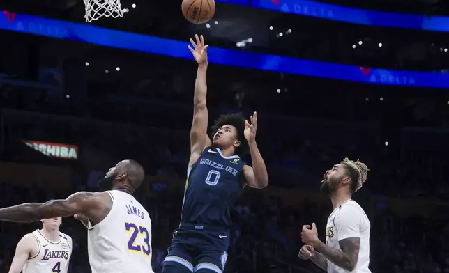 Memphis Grizzlies forward Jaylen Wells (0) shoots as Los Angeles Lakers guard D'Angelo Russell and forward LeBron James (23) watch during the first half of an NBA basketball game, Sunday, Dec. 15, 2024, in Los Angeles. (AP Photo/Jessie Alcheh)