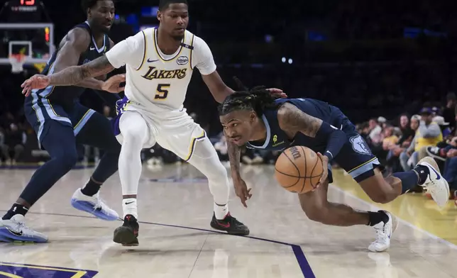 Memphis Grizzlies guard Ja Morant (12) drives against Los Angeles Lakers forward Cam Reddish (5) as Memphis Grizzlies forward Jaren Jackson Jr. watches during the first half of an NBA basketball game, Sunday, Dec. 15, 2024, in Los Angeles. (AP Photo/Jessie Alcheh)