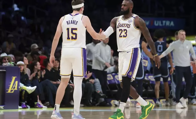 Los Angeles Lakers forward LeBron James (23) celebrates with guard Austin Reaves (15) during the first half of an NBA basketball game against the Memphis Grizzlies, Sunday, Dec. 15, 2024, in Los Angeles. (AP Photo/Jessie Alcheh)