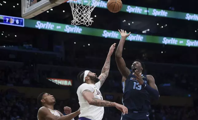 Memphis Grizzlies forward Jaren Jackson Jr. (13) shoots against Los Angeles Lakers forward Anthony Davis as forward Rui Hachimura (28) watches during the first half of an NBA basketball game, Sunday, Dec. 15, 2024, in Los Angeles. (AP Photo/Jessie Alcheh)