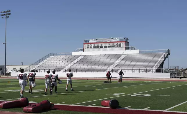 The football team practices on a new field at Watonga High School, Wednesday, Oct. 2, 2024, where about 14% of students at the school on the Cheyenne-Arapaho reservation are Native American in Watonga, Okla. (AP Photo/Nick Oxford)