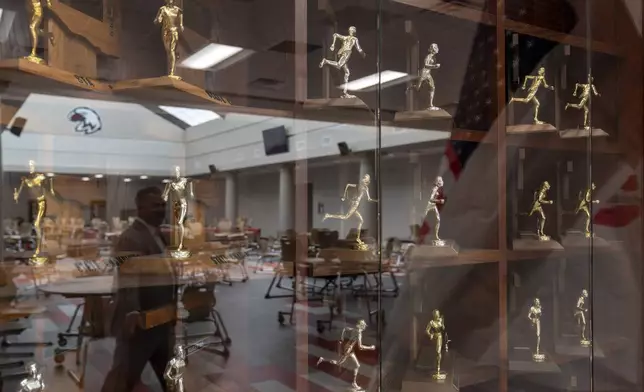 Trophies are displayed in a case at Watonga High School where about 14% of students at the school on the Cheyenne-Arapaho reservation are Native American, Wednesday, Oct. 2, 2024, in Watonga, Okla. (AP Photo/Nick Oxford)