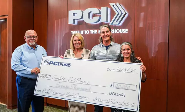 Tina Tavares Powderly (right), Executive Director of Franklin Food Pantry, is all smiles after being presented with a grant from PCI for her organization. Sharing the moment are (from left) PCI's Ismael Diaz, President &amp; CEO, and Founders Arturo and Susan Echarte. The handover took place at the annual PCI Powerhouse Fund Gratitude Gathering Event at PCI's Southeast headquarters in Florida. (Photo: Business Wire)