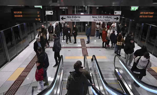 Commuters inside a metro station during the inauguration day of the Thessaloniki metro, in Thessaloniki, northern Greece, Saturday, Nov. 30, 2024. (AP Photo/Giannis Papanikos)