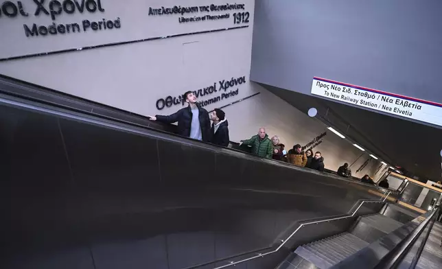 Commuters use the ecalator at a metro station during the inauguration day of the Thessaloniki metro, in Thessaloniki, northern Greece, Saturday, Nov. 30, 2024. (AP Photo/Giannis Papanikos)