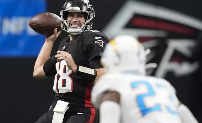 Atlanta Falcons quarterback Kirk Cousins (18) passes during the second half of an NFL football game against the Los Angeles Chargers on Sunday, Dec. 1, 2024 in Atlanta. (AP Photo/Mike Stewart)