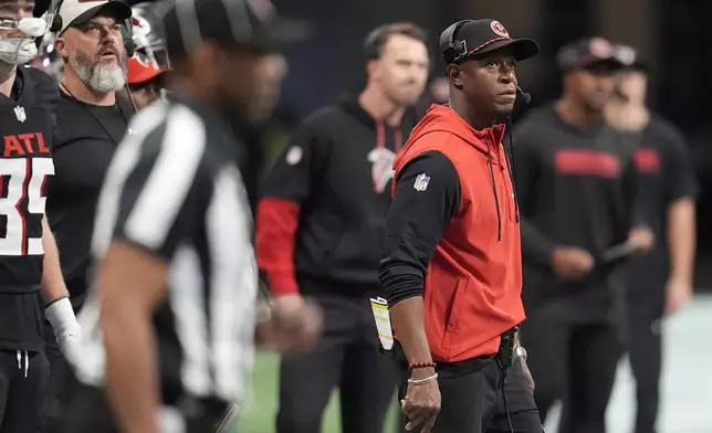 Atlanta Falcons head coach Raheem Morris watches from the sidelines during the first half of an NFL football game against the Los Angeles Chargers on Sunday, Dec. 1, 2024 in Atlanta. (AP Photo/Mike Stewart)