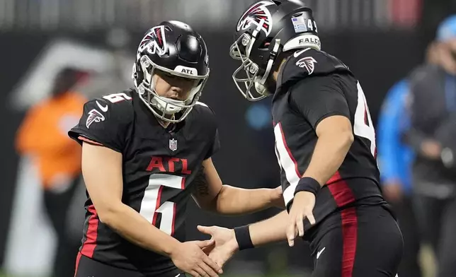 Atlanta Falcons place-kicker Younghoe Koo (6) celebrates with teammate during the second half of an NFL football game against the Los Angeles Chargers on Sunday, Dec. 1, 2024 in Atlanta. (AP Photo/Mike Stewart)