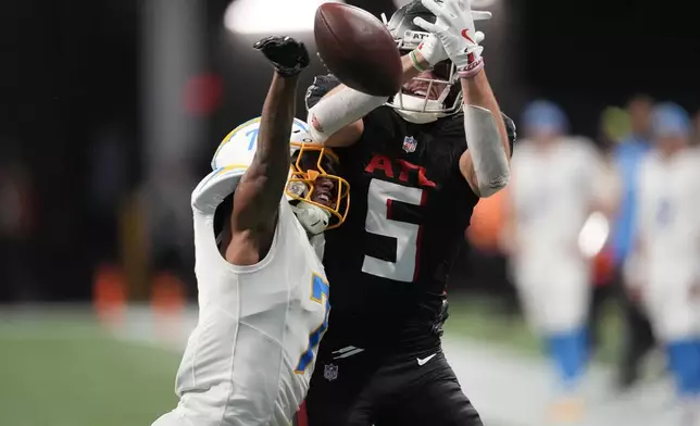 Los Angeles Chargers cornerback Kristian Fulton (7) breaks up a pass intended for Atlanta Falcons wide receiver Drake London (5) during the second half of an NFL football game on Sunday, Dec. 1, 2024 in Atlanta. (AP Photo/John Bazemore)