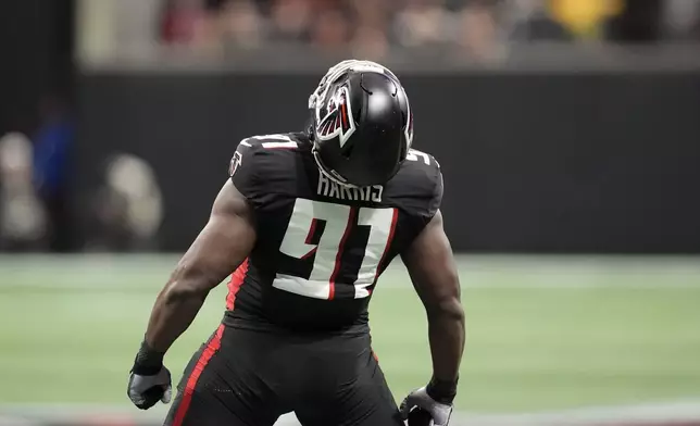 Atlanta Falcons defensive end Demone Harris (91) celebrates a sac against Los Angeles Chargers quarterback Justin Herbert (10) during the first half of an NFL football game on Sunday, Dec. 1, 2024 in Atlanta.(AP Photo/Mike Stewart)