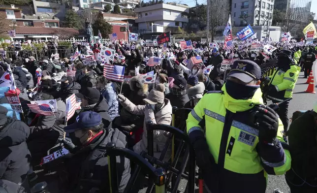 Supporters of impeached South Korean President Yoon Suk Yeol stage a rally after hearing a news that a court issued warrants to detain Yoon, near the presidential residence in Seoul, South Korea, Tuesday, Dec. 31, 2024. (AP Photo/Lee Jin-man)