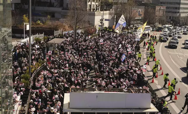 Supporters of impeached South Korean President Yoon Suk Yeol stage a rally near the presidential residence in Seoul, South Korea, Tuesday, Dec. 31, 2024. (AP Photo/Lee Jin-man)